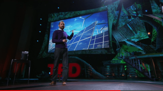 風力発電と太陽光発電のスライドを指差すアレックス・ラスキー氏